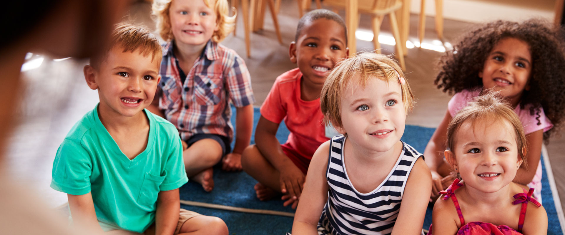 Diverse group of happy children sitting together